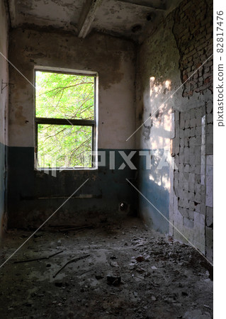 Window light illuminates an abandoned room. Abandoned brick building. Window light illuminates an abandoned room. Abandoned brick building. 82817476