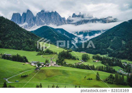 St Magdalena church in Val di Funes valley, Dolomites, Italy. Furchetta and Sass Rigais mountain peaks in background St Magdalena church in Val di Funes valley, Dolomites, Italy. Furchetta and Sass Rigais mountain peaks in background 82818169