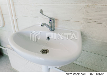 View of a new toilet and bathroom interior for hospital, white and clean 82818684