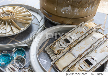 Parts of the washing machine are filled with mold,algae or rust stains and dirt,preparing to clean and clear the washer drum,check,repair equipment or maintenance of household electrical appliances 82818979