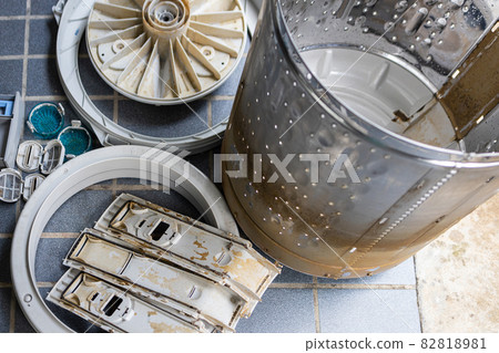 Disassemble the laundry washing machine parts to clean and clear the washer drum,removes mold,algae stains and dirt inside the drum,eliminate musty odors,stale smell of a machine for washing clothes 82818981