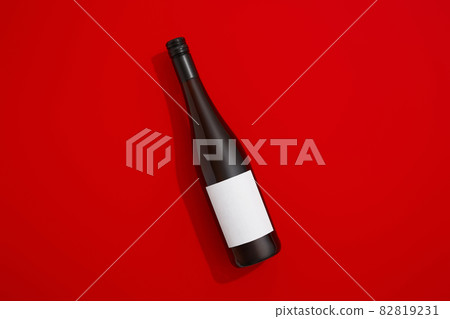 Wine bottle with blank label. Red wine on colorful background with copy space Wine bottle with blank label. Red wine on colorful background with copy space 82819231