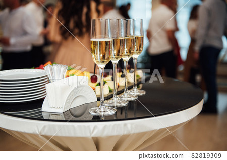glasses with champagne and fruits on buffet table at a restaurant or in the hotel lobby 82819309