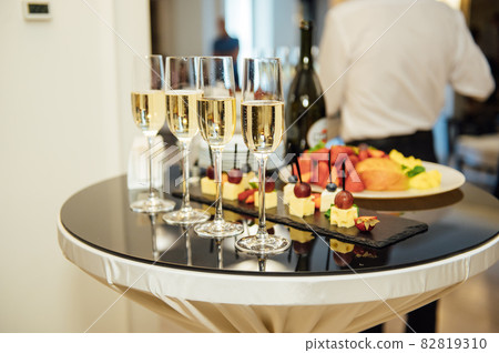 glasses with champagne and fruits on buffet table at a restaurant or in the hotel lobby 82819310