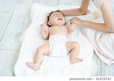 Baby crying in a diaper 82819781