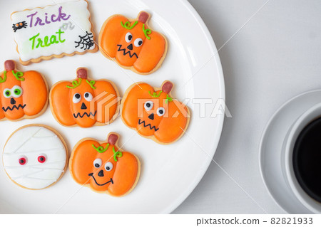 hot coffee cup with funny Halloween Cookies. Happy Halloween day, Trick or Threat, Hello October, fall autumn, Traditional, party and holiday concept 82821933