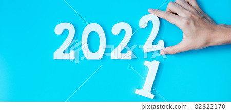 hand change 2021 to 2022 number on blue background. Plan, finance, Resolution, strategy, solution, goal, business and New Year holiday concepts hand change 2021 to 2022 number on blue background. Plan, finance, Resolution, strategy, solution, goal, business and New Year holiday concepts 82822170