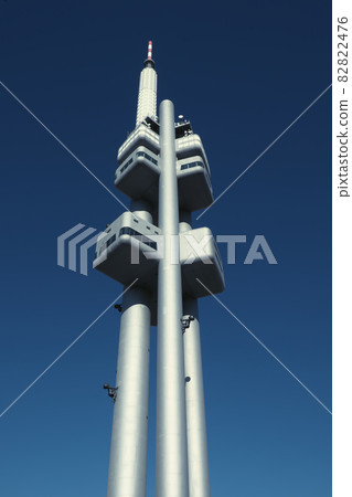 Zizkov television tower against the blue sky. Zizkov television tower against the blue sky. 82822476