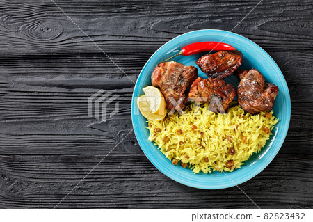 roasted meat served with raisins saffron rice 82823432