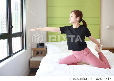 woman stretch her arm on bed 82824517