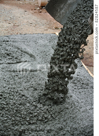 MALACCA, MALAYSIA -FEBRUARY 05, 2016: Fresh wet concrete is poured on top slab form work form a solid concrete slab when it has been hard. MALACCA, MALAYSIA -FEBRUARY 05, 2016: Fresh wet concrete is poured on top slab form work form a solid concrete slab when it has been hard. 82824587