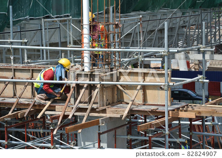 PERAK, MALAYSIA -APRIL 10, 2016: Construction workers fabricating timber form work mostly using timber and plywood at the construction site in Perak, Malaysia.   82824907