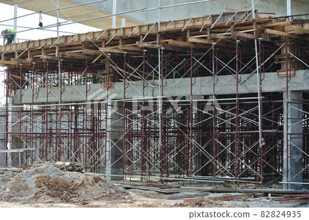 JOHOR, MALAYSIA -APRIL 13, 2016: Scaffolding used as the temporary structure to support platform, form work and structure at the construction site. Also used it as a walking platform for workers.  82824935