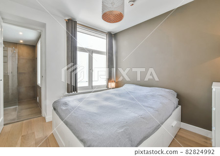 Interior of a cozy and bright bedroom with beautiful decoration Interior of a cozy and bright bedroom with beautiful decoration 82824992