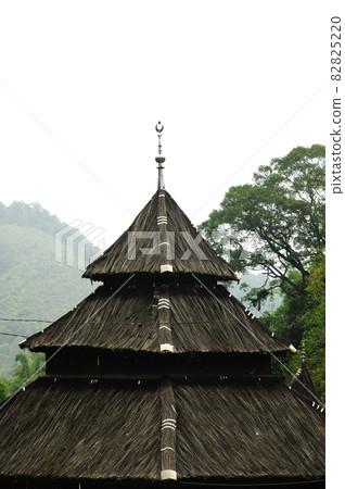 WEST SUMATERA, INDONESIA -JUNE 8, 2014: Tuo Kayu Jao Mosque is located in West Sumatra, Indonesia. Built in 1599 and is the second oldest mosque in Indonesia. WEST SUMATERA, INDONESIA -JUNE 8, 2014: Tuo Kayu Jao Mosque is located in West Sumatra, Indonesia. Built in 1599 and is the second oldest mosque in Indonesia. 82825220