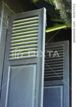 WEST SUMATERA, INDONESIA -JUNE 8, 2014: Traditional timber window at Tuo Kayu Jao Mosque in West Sumatra, Indonesia. Built in 1599 and is the second oldest mosque in Indonesia. WEST SUMATERA, INDONESIA -JUNE 8, 2014: Traditional timber window at Tuo Kayu Jao Mosque in West Sumatra, Indonesia. Built in 1599 and is the second oldest mosque in Indonesia. 82825312