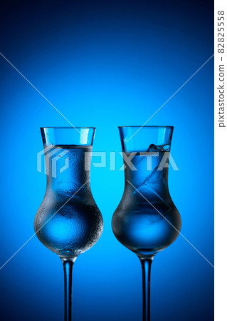 Strong alcoholic drink in frozen glasses with ice. Strong alcoholic drink in frozen glasses with ice. 82825558