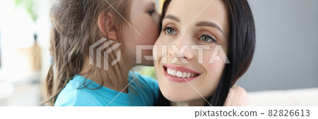 Little girl whispers secret in mom ear Little girl whispers secret in mom ear 82826613
