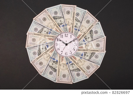 Concept of clock and dollar. Clock on mandala kaleidoscope from money. Abstract money background raster pattern repeat mandala circle. 82826697