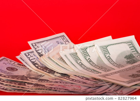 Dollars on a red background. Gambling and casino concept. Dollars on a red background. Gambling and casino concept. 82827964