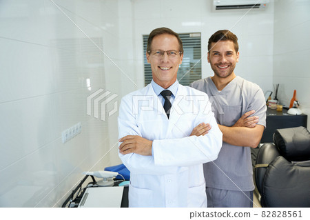 Two male dentists smiling and looking professional Two male dentists smiling and looking professional 82828561