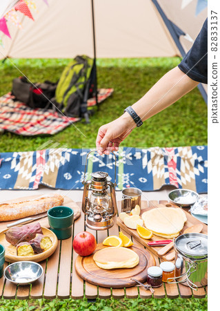 A man lifting a lantern in a fashionable day camp at Akigase Park in Saitama Prefecture A man lifting a lantern in a fashionable day camp at Akigase Park in Saitama Prefecture 82833137