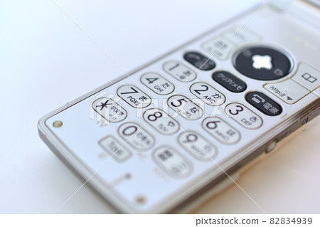 White bi-fold mobile phone feature phone White bi-fold mobile phone feature phone 82834939