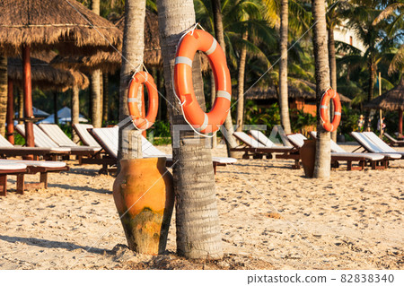 orange lifebuoy ring on tropical beach orange lifebuoy ring on tropical beach 82838340