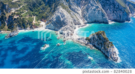 Aerial view Agia Eleni beach in Kefalonia Island, Greece. Remote beautiful rocky beach with clear emerald water and high white cliffs Aerial view Agia Eleni beach in Kefalonia Island, Greece. Remote beautiful rocky beach with clear emerald water and high white cliffs 82840028