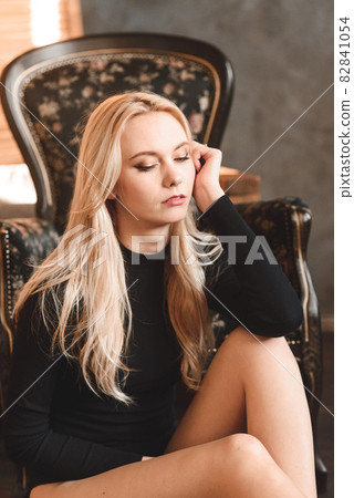Woman in black bodysuit. girl with wavy hair. Sensual gorgeous young lady in black bodysuit posing in the studio Woman in black bodysuit. girl with wavy hair. Sensual gorgeous young lady in black bodysuit posing in the studio 82841054