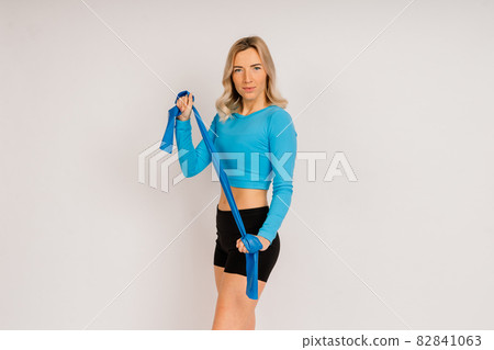 Attractive blonde caucasian smiling woman isolated on white, blue. Studio shot looking at camera Attractive blonde caucasian smiling woman isolated on white, blue. Studio shot looking at camera 82841063