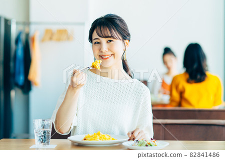 Young woman eating lunch at a restaurant Young woman eating lunch at a restaurant 82841486