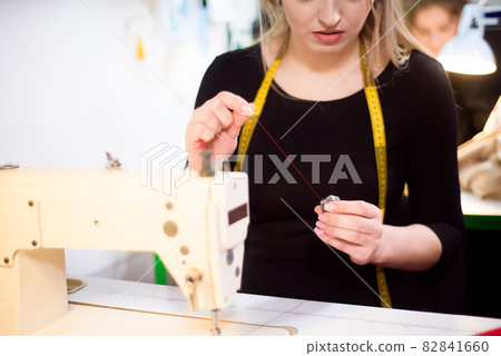 Process of working with sewing machine in an atelier. Process of working with sewing machine in an atelier. 82841660