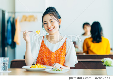 Young woman eating out at a restaurant Young woman eating out at a restaurant 82842334