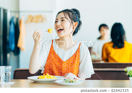 Young woman eating out at a restaurant 82842335