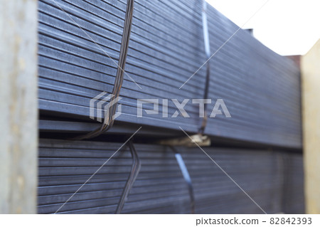 Metal profile pipe of rectangular cross section in packs at the warehouse of metal products Metal profile pipe of rectangular cross section in packs at the warehouse of metal products 82842393