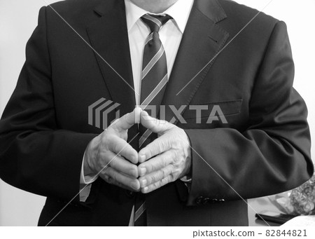 Man holding hands together 82844821