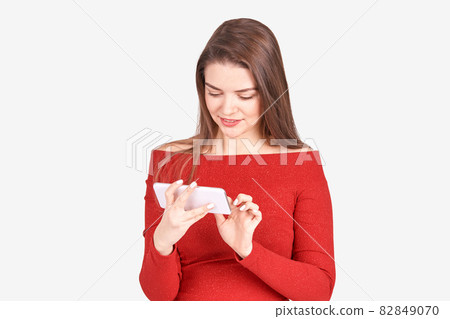 Pretty young woman with phone. Studio portrait. Female person. 82849070