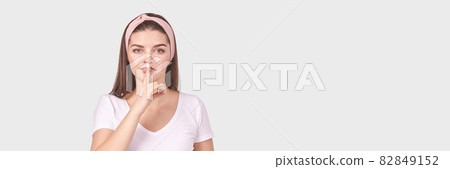 Pretty young woman gesture. Studio portrait. Female person. 82849152