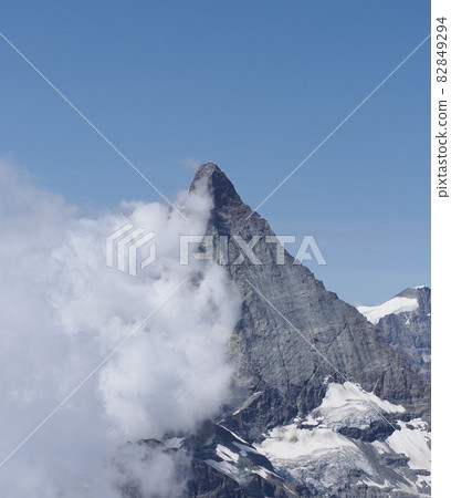 Matterhorn, Cervino mountain in clouds in Switzerland - vertical Matterhorn, Cervino mountain in clouds in Switzerland - vertical 82849294