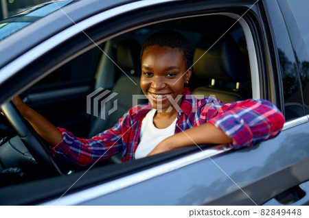 Woman poses in shinning car, auto wash station Woman poses in shinning car, auto wash station 82849448