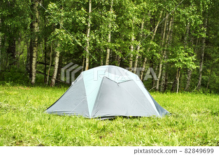 Tent camp in forest. Local travel concept. Sustainable lifestyle. Summer Tent camp in forest. Local travel concept. Sustainable lifestyle. Summer 82849699