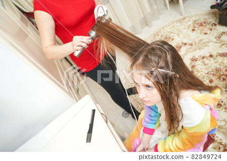 Mother dry daughter hair. Home activity. New normal. Barber equipment 82849724