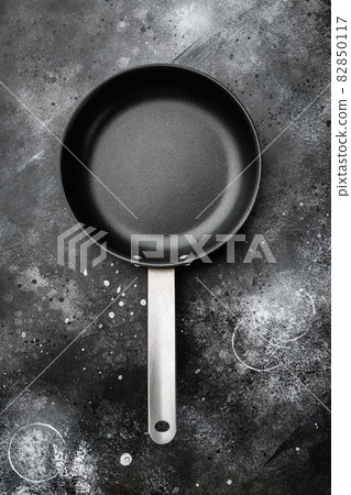 Empty frying pan with copy space for text or food with copy space for text or food, top view flat lay , on black dark stone table background 82850117