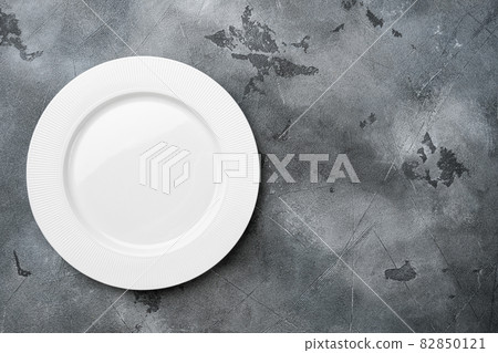 White plate empty utensil with copy space for text or food with copy space for text or food, top view flat lay , on gray stone table background White plate empty utensil with copy space for text or food with copy space for text or food, top view flat lay , on gray stone table background 82850121