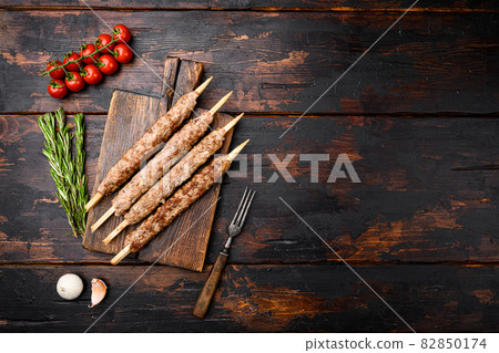 Tikka, shish and kofta kebabs, on old dark wooden table background, top view flat lay, with copy space for text 82850174