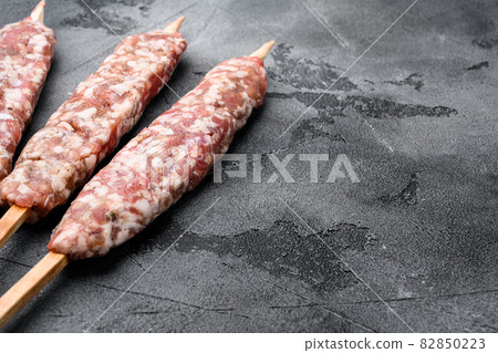 Lyulya kebab, meat dish for cooking, on gray stone table background, with copy space for text Lyulya kebab, meat dish for cooking, on gray stone table background, with copy space for text 82850223