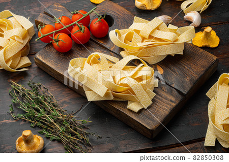 Fresh ingredients for cooking pasta, on old dark wooden table background Fresh ingredients for cooking pasta, on old dark wooden table background 82850308