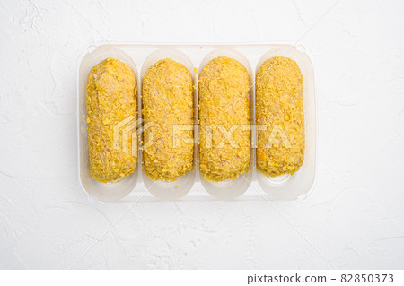Fresh chicken cutlets prepared for frying, in plastic market container, on white stone table background, top view flat lay, with copy space for text Fresh chicken cutlets prepared for frying, in plastic market container, on white stone table background, top view flat lay, with copy space for text 82850373