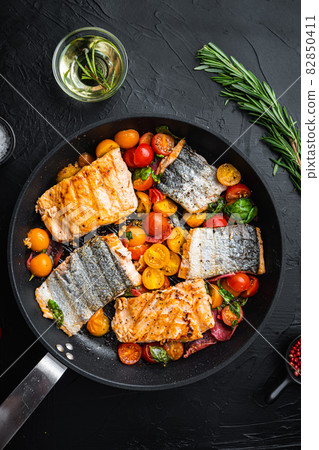 Smoky chorizosalmon grilled with cherry tomatoes on black background, top view Smoky chorizosalmon grilled with cherry tomatoes on black background, top view 82850411